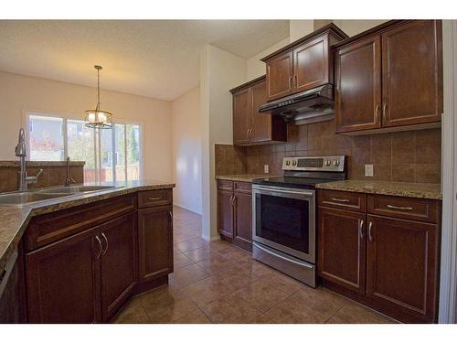 109 Bridlerange Place Sw, Calgary, AB - Indoor Photo Showing Kitchen With Double Sink