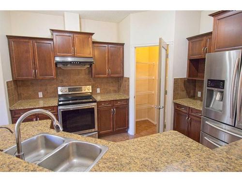 109 Bridlerange Place Sw, Calgary, AB - Indoor Photo Showing Kitchen With Double Sink