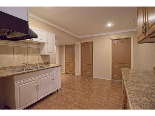 109 Bridlerange Place Sw, Calgary, AB - Indoor Photo Showing Kitchen With Double Sink