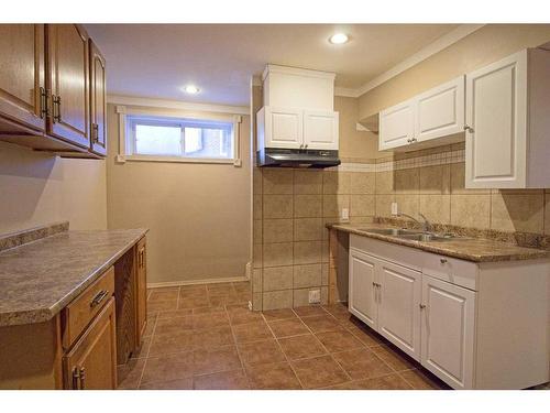 109 Bridlerange Place Sw, Calgary, AB - Indoor Photo Showing Kitchen With Double Sink