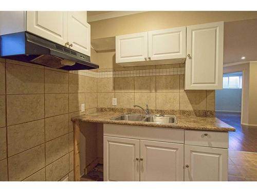 109 Bridlerange Place Sw, Calgary, AB - Indoor Photo Showing Kitchen With Double Sink