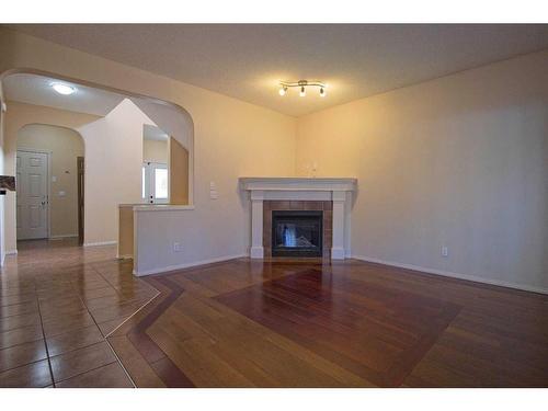 109 Bridlerange Place Sw, Calgary, AB - Indoor Photo Showing Living Room With Fireplace