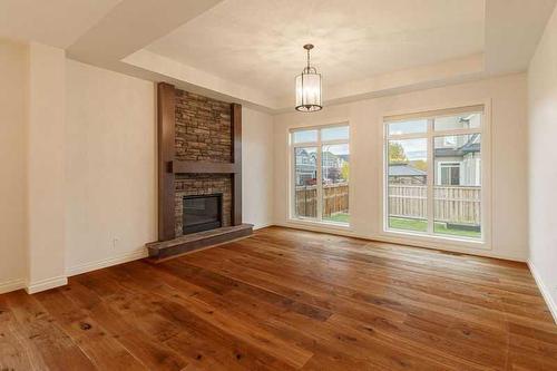 309 Marquis Landing Se, Calgary, AB - Indoor Photo Showing Living Room With Fireplace