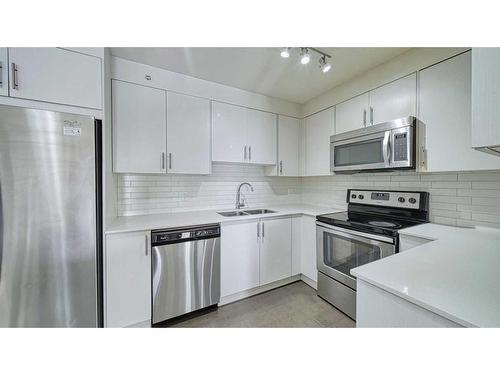 1406-302 Skyview Ranch Drive Ne, Calgary, AB - Indoor Photo Showing Kitchen With Stainless Steel Kitchen With Double Sink With Upgraded Kitchen