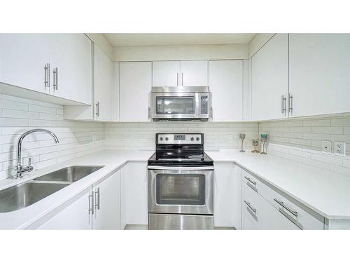 1406-302 Skyview Ranch Drive Ne, Calgary, AB - Indoor Photo Showing Kitchen With Stainless Steel Kitchen With Double Sink With Upgraded Kitchen