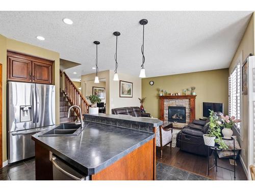 173 Everoak Circle Sw, Calgary, AB - Indoor Photo Showing Kitchen With Fireplace With Double Sink