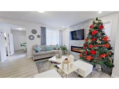 150 Yorkville Green Sw, Calgary, AB - Indoor Photo Showing Living Room With Fireplace