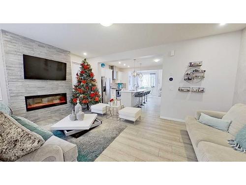 150 Yorkville Green Sw, Calgary, AB - Indoor Photo Showing Living Room With Fireplace