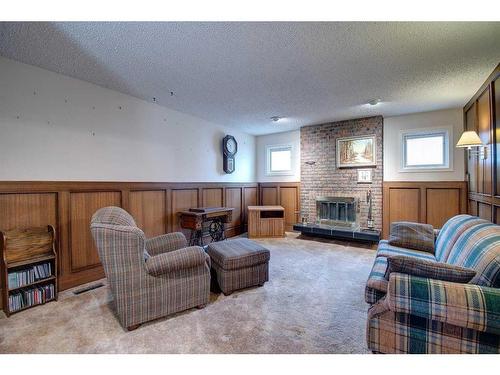 195 Silver Crest Crescent Nw, Calgary, AB - Indoor Photo Showing Living Room With Fireplace