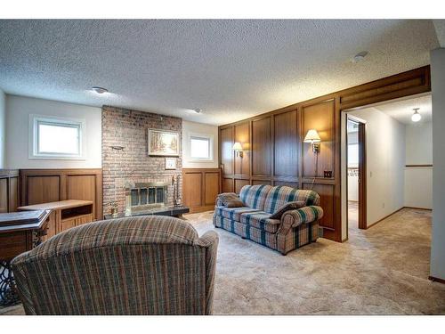 195 Silver Crest Crescent Nw, Calgary, AB - Indoor Photo Showing Living Room With Fireplace