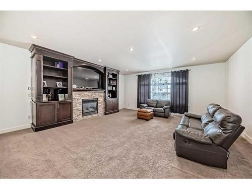 16 Rockcliff Point Nw, Calgary, AB - Indoor Photo Showing Other Room With Fireplace