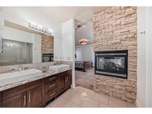 16 Rockcliff Point Nw, Calgary, AB - Indoor Photo Showing Bathroom With Fireplace