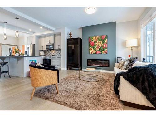 382 Sundown Road, Cochrane, AB - Indoor Photo Showing Living Room With Fireplace