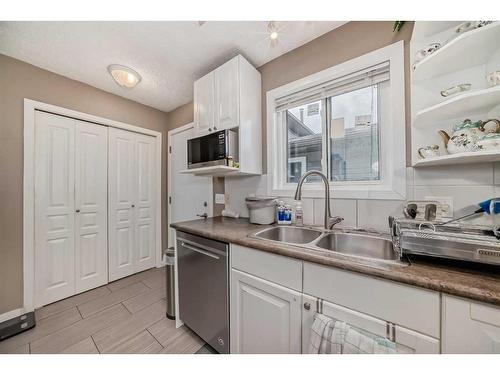 16 Taraglen Road Ne, Calgary, AB - Indoor Photo Showing Kitchen With Double Sink