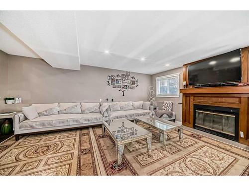 16 Taraglen Road Ne, Calgary, AB - Indoor Photo Showing Living Room With Fireplace