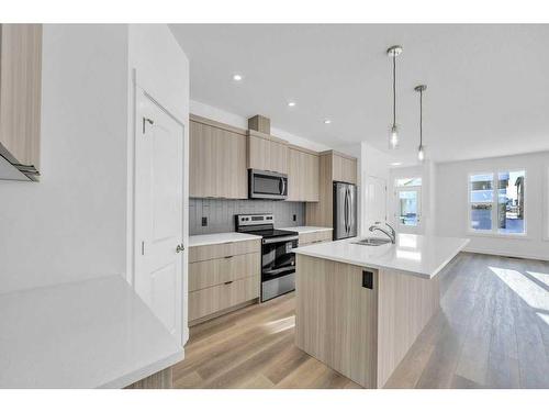 1115 Chinnok Winds Circle Sw, Airdrie, AB - Indoor Photo Showing Kitchen With Stainless Steel Kitchen With Upgraded Kitchen