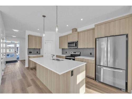 1115 Chinnok Winds Circle Sw, Airdrie, AB - Indoor Photo Showing Kitchen With Stainless Steel Kitchen With Double Sink With Upgraded Kitchen