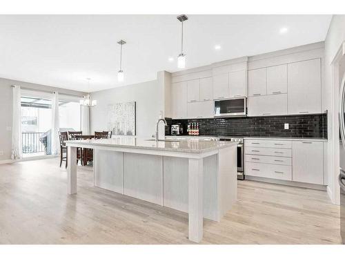 11 Willow Park Point, Cochrane, AB - Indoor Photo Showing Kitchen With Upgraded Kitchen