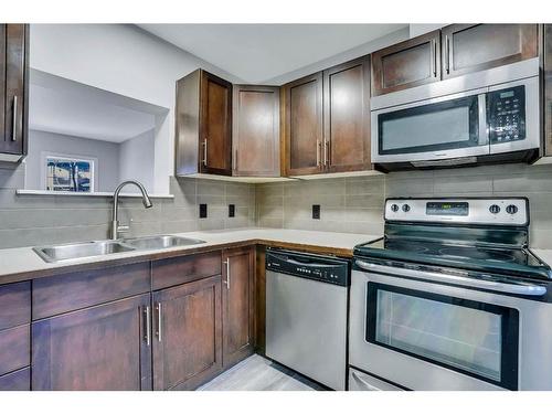 151 Panatella Road Nw, Calgary, AB - Indoor Photo Showing Kitchen With Double Sink