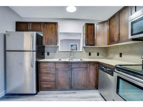 151 Panatella Road Nw, Calgary, AB - Indoor Photo Showing Kitchen With Double Sink