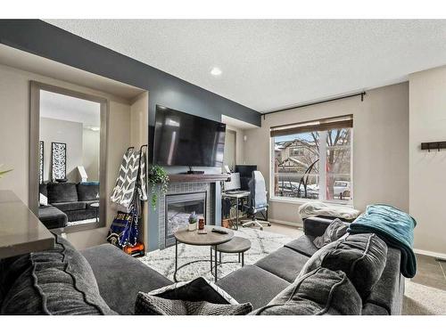 163 Chapalina Square Se, Calgary, AB - Indoor Photo Showing Living Room With Fireplace