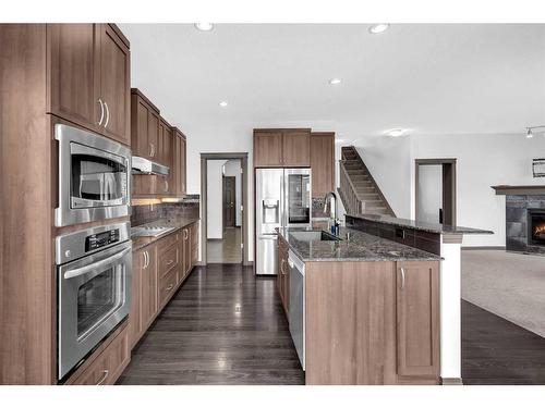 1121 Kingston Crescent Se, Airdrie, AB - Indoor Photo Showing Kitchen With Fireplace With Upgraded Kitchen