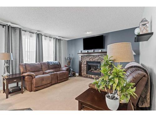 1712 High Park Boulevard Nw, High River, AB - Indoor Photo Showing Living Room With Fireplace