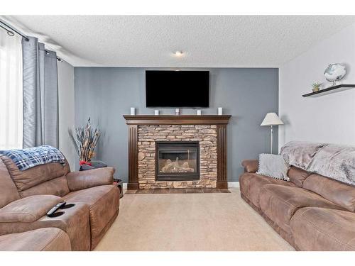 1712 High Park Boulevard Nw, High River, AB - Indoor Photo Showing Living Room With Fireplace