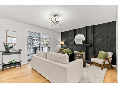 220 Queen Anne Place Se, Calgary, AB - Indoor Photo Showing Living Room With Fireplace