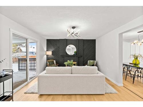 220 Queen Anne Place Se, Calgary, AB - Indoor Photo Showing Living Room With Fireplace