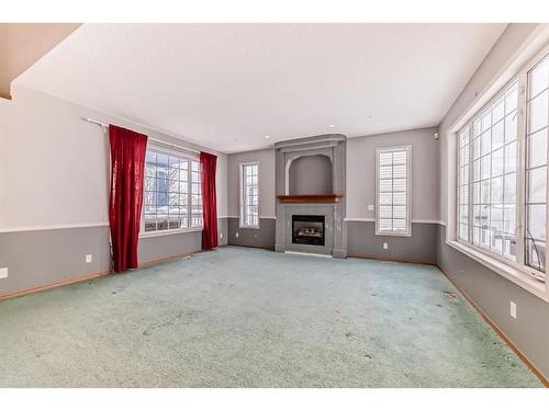 7 Wilson Road Ne, Langdon, AB - Indoor Photo Showing Other Room With Fireplace