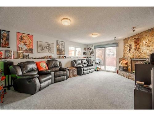 72 Beaconsfield Way Nw, Calgary, AB - Indoor Photo Showing Living Room With Fireplace