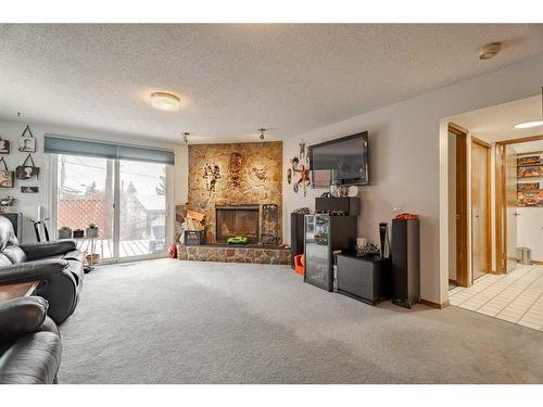 72 Beaconsfield Way Nw, Calgary, AB - Indoor Photo Showing Living Room With Fireplace