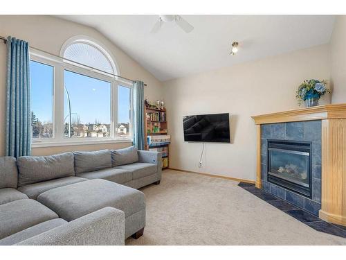 185 Simcoe Circle Sw, Calgary, AB - Indoor Photo Showing Living Room With Fireplace