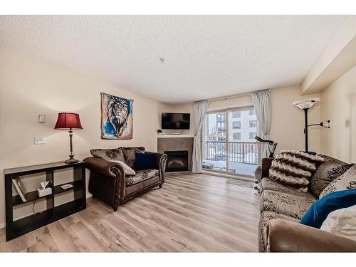 1215-16969 24 Street Sw, Calgary, AB - Indoor Photo Showing Living Room With Fireplace