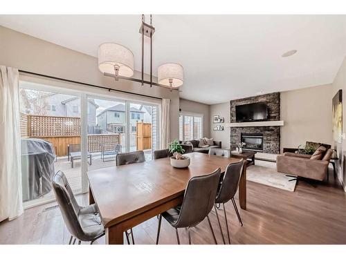 54 Copperpond Heath Se, Calgary, AB - Indoor Photo Showing Dining Room With Fireplace