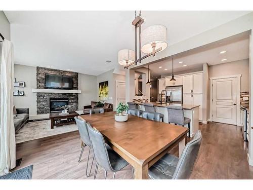 54 Copperpond Heath Se, Calgary, AB - Indoor Photo Showing Dining Room With Fireplace