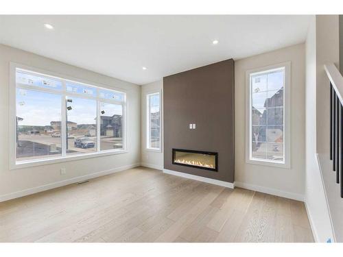 156 Sundown Crescent, Cochrane, AB - Indoor Photo Showing Living Room With Fireplace