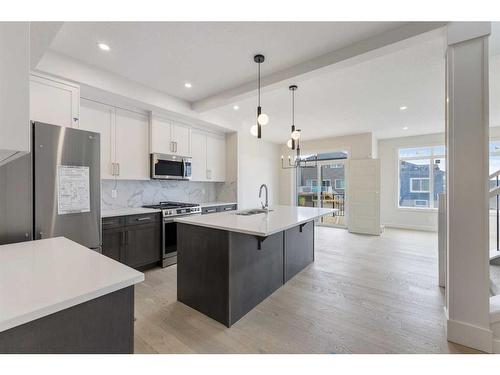 156 Sundown Crescent, Cochrane, AB - Indoor Photo Showing Kitchen With Double Sink With Upgraded Kitchen