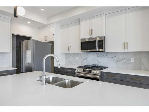 156 Sundown Crescent, Cochrane, AB - Indoor Photo Showing Kitchen With Double Sink With Upgraded Kitchen