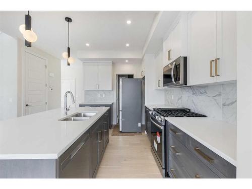 156 Sundown Crescent, Cochrane, AB - Indoor Photo Showing Kitchen With Double Sink With Upgraded Kitchen