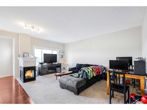 146 Bridlerange Place Sw, Calgary, AB - Indoor Photo Showing Other Room With Fireplace