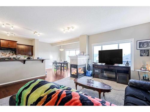 146 Bridlerange Place Sw, Calgary, AB - Indoor Photo Showing Living Room With Fireplace