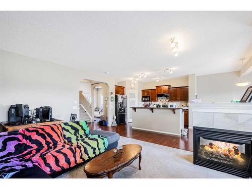 146 Bridlerange Place Sw, Calgary, AB - Indoor Photo Showing Living Room With Fireplace