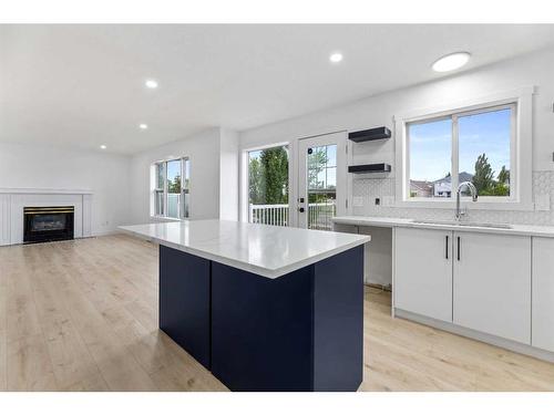 80 Sceptre Close Nw, Calgary, AB - Indoor Photo Showing Kitchen With Fireplace