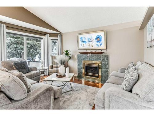 357 Martinwood Place Ne, Calgary, AB - Indoor Photo Showing Living Room With Fireplace