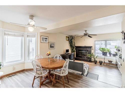 72 Deerpath Road Se, Calgary, AB - Indoor Photo Showing Dining Room With Fireplace