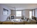 144 Mt Aberdeen Manor Se, Calgary, AB  - Indoor Photo Showing Living Room With Fireplace 