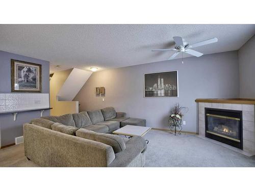 144 Mt Aberdeen Manor Se, Calgary, AB - Indoor Photo Showing Living Room With Fireplace