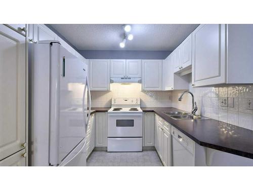 144 Mt Aberdeen Manor Se, Calgary, AB - Indoor Photo Showing Kitchen With Double Sink